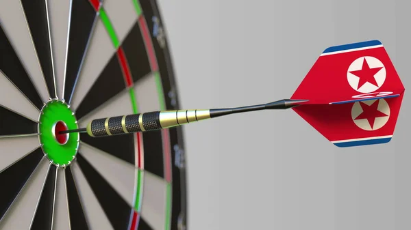 Dart featuring flag of North Korea hits bullseye of the target. Sports or political success related conceptual 3D rendering — Stock Photo, Image