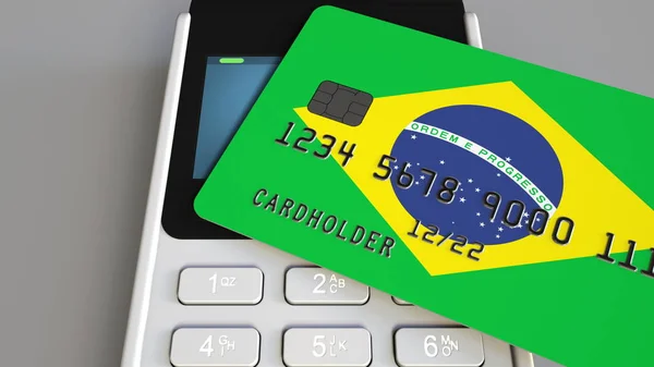 Payment or POS terminal with credit card featuring flag of Brazil. Brazilian retail commerce or banking system conceptual 3D rendering — Stock Photo, Image