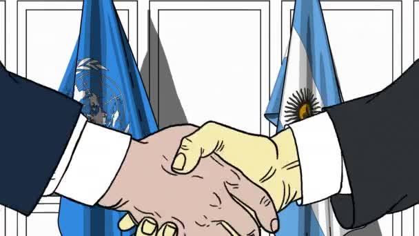Επιχειρηματίες ή πολιτικοί χειραψία κατά σημαίες των Ηνωμένων Εθνών και την Αργεντινή. Επίσημη συνάντηση ή συνεργασίας που σχετίζονται με εκδοτική κίνηση — Αρχείο Βίντεο