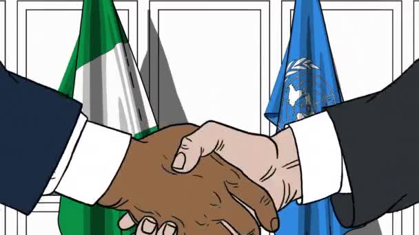 Підприємці або політиків потиснути один одному руки проти прапори Нігерії і організації Об'єднаних Націй. Офіційна зустріч або співпраці пов'язані з редакційних анімації — стокове відео
