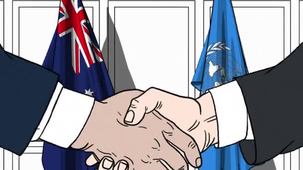 Uomini d'affari o politici stringono la mano contro le bandiere dell'Australia e delle Nazioni Unite. Riunione ufficiale o animazione editoriale relativa alla cooperazione — Video Stock
