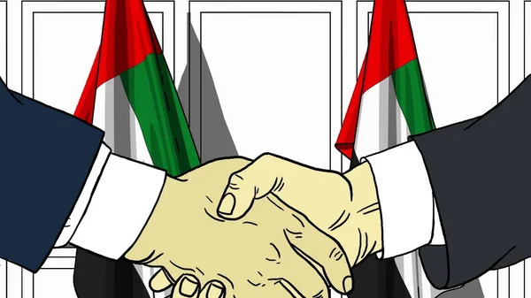 Бизнесмены или политики пожимают руку флагу ОАЭ. Официальная иллюстрация встречи или сотрудничества — стоковое фото