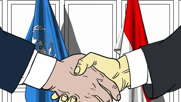 Бизнесмены или политики пожимают руку флагу ООН и Индонезии. Официальная редакционная иллюстрация встречи или сотрудничества — стоковое фото