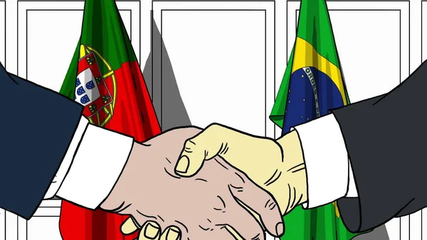 Бизнесмены или политики пожимают руку флагу Португалии и Бразилии. Официальная иллюстрация встречи или сотрудничества — стоковое фото