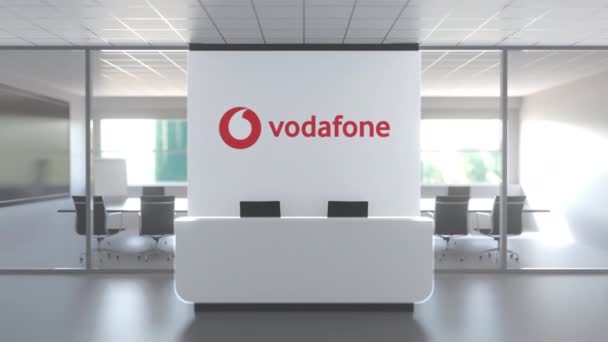Логотип Vodafone вище приймального столу в сучасному офісі, редакційна концептуальна 3D анімація — стокове відео
