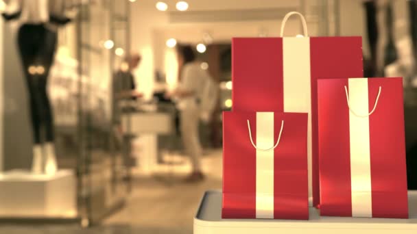 Flag of Latvia on the paper shopping bags against blurred store entrance. Retail related clip — Stock Video