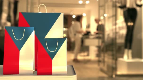 Flag of the Czech Republic on the paper shopping bags against blurred store entrance. Retail related clip — Αρχείο Βίντεο