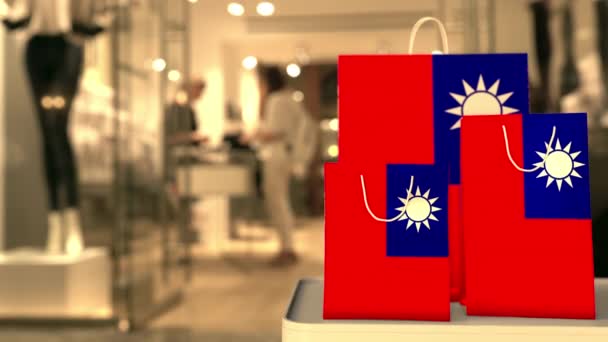 Flag of Taiwan on the paper shopping bags against blurred store entrance. Retail related clip — 图库视频影像