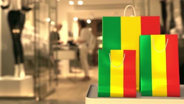 Flag of Bolivia on the paper shopping bags against blurred store entrance. Retail related clip — Stock Video