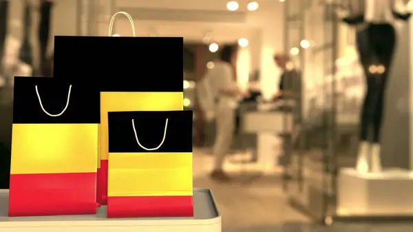 Vlag van België op de papieren boodschappentassen tegen wazige winkelingang. Retailgerelateerde 3d-rendering — Stockfoto