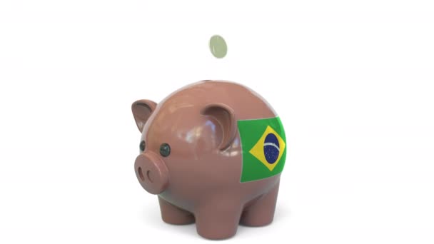 Putting money into piggy bank with flag of Brazil. Tax system system or savings related conceptual 3D animation — Stock Video