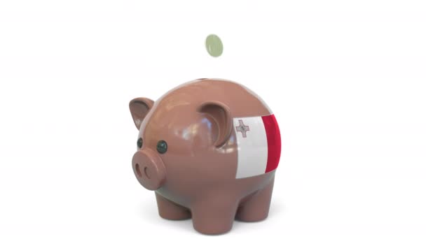 Putting money into piggy bank with flag of Malta. Tax system system or savings related conceptual 3D animation — Stockvideo