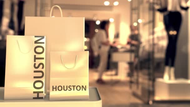 Shopping bag con testo HOUSTON contro negozio sfocato. Clip al dettaglio americano — Video Stock