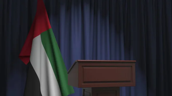 Флаг Объединённых Арабских Эмиратов и трибуна спикера. Политическое событие или заявление, связанное с концептуальным 3D рендерингом — стоковое фото