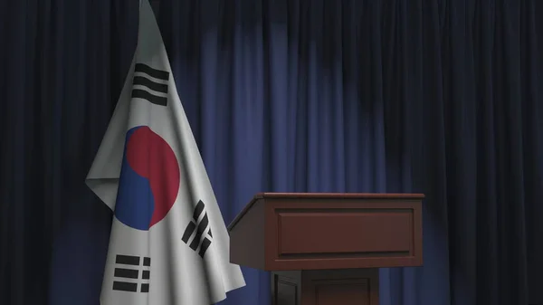 Flag of South Korea and speaker podium tribune. Political event or statement related conceptual 3D rendering — ストック写真