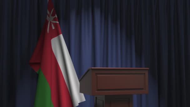 Flag of Oman and speaker podium tribune. Political event or statement related conceptual 3D animation — ストック動画