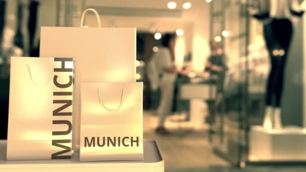 Paper bags with Munich text. Shopping in Germany related 3D animation — Stock Video