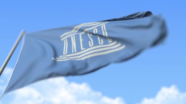 Flying flag of UNESCO, low angle view. Editorial loopable realistic slow motion 3D animation — 图库视频影像