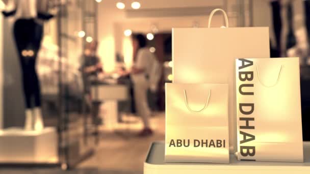 Bolsas de compras con texto de Abu Dhabi. Compras en Emiratos Árabes Unidos animación 3D conceptual relacionada — Vídeo de stock
