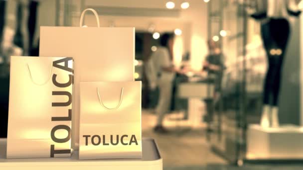 Einkaufstaschen mit Toluca-Text. Einkaufen in Mexiko im Zusammenhang mit 3D-Animation — Stockvideo