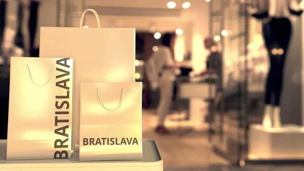 Papieren boodschappentassen met Bratislava onderschrift tegen wazige winkelingang. Detailhandel in Slowaakse gerelateerde conceptuele 3d-rendering — Stockfoto