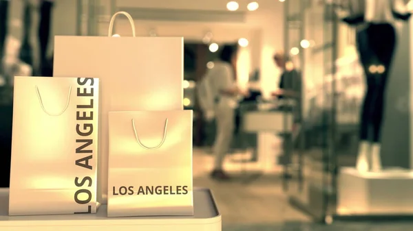 Bolsas de papel con pie de foto de Los Ángeles contra la entrada borrosa de la tienda. Venta al por menor en los Estados Unidos renderizado 3D relacionado —  Fotos de Stock