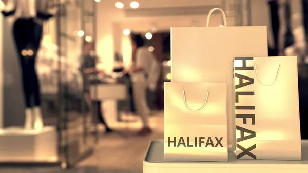 Einkaufstüten mit Halogen-Schriftzug vor verschwommenem Ladeneingang. Shopping in Kanada im Zusammenhang mit konzeptionellen 3D-Rendering — Stockfoto