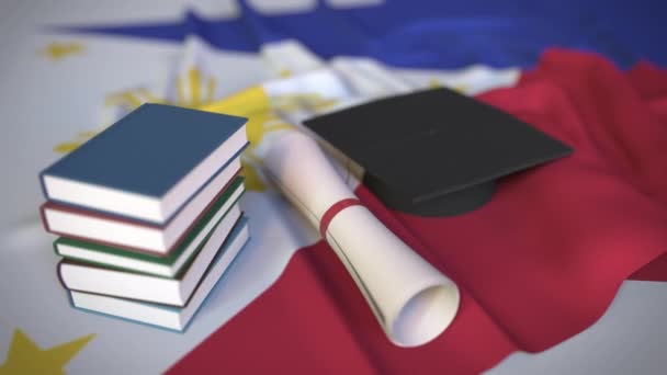 Tapa de graduación, libros y diploma en la bandera. Educación superior en Filipinas relacionada con la animación conceptual 3D — Vídeo de stock