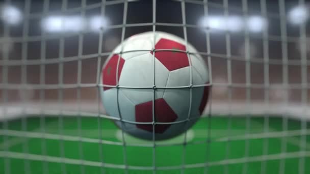 Football with flags of Morocco in net against blurred stadium. Conceptual 3D animation — ストック動画