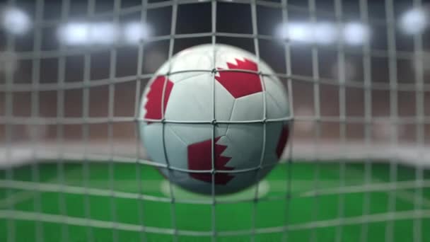 Football with flags of Bahrain hits goal net. Slow motion 3D animation — Stock Video