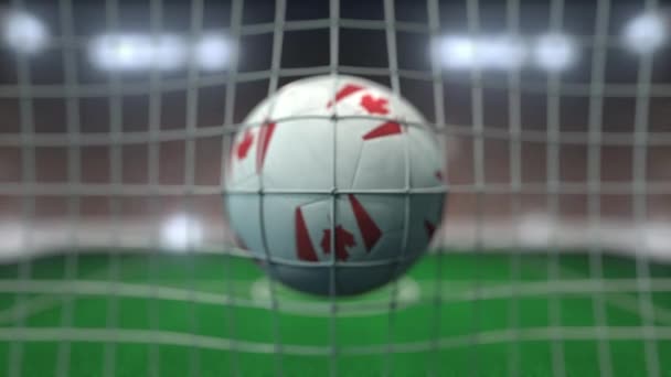 Football with flags of Canada hits goal net. Slow motion 3D animation — ストック動画