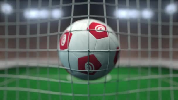 Piłka nożna z flagami Tunezji w siatce przeciwko zamglonemu stadionowi. Animacja konceptualna 3d — Wideo stockowe