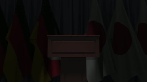 Flaggen von Deutschland und Japan und Rednerpult. politische Veranstaltung oder Verhandlungen im Zusammenhang mit konzeptioneller 3D-Animation — Stockvideo
