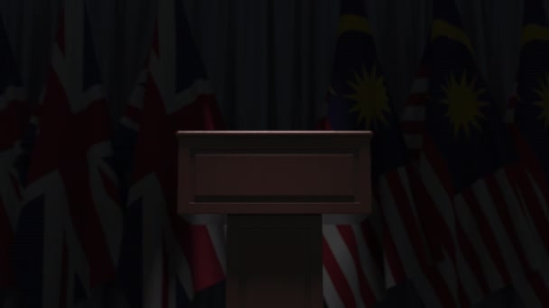 Bandeiras da Malásia e do Reino Unido e tribuno, animação 3D — Vídeo de Stock