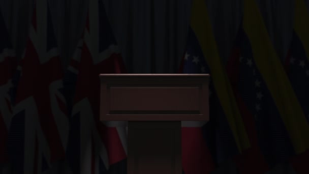 Many flags of Venezuela and the United Kingdom behind speaker tribune, 3D animation — ストック動画