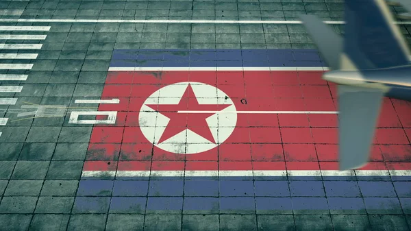 İniş yapan bir uçağın hava görüntüsü Kuzey Kore 'nin bayrağını bir havaalanının havaalanında gösteriyor. Hava yolculuğuyla ilgili kavramsal 3d oluşturma — Stok fotoğraf