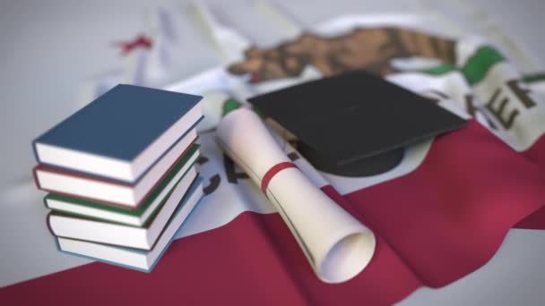 Graduation cap, books and diploma on the flag of California. Higher education in the USA related conceptual 3D animation — Stock Video