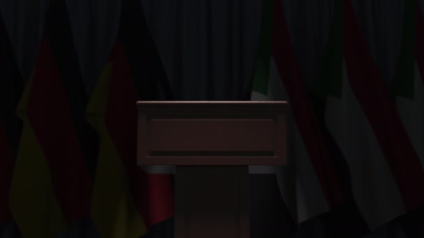Muchas banderas de Sudán y Alemania detrás tribuna altavoz, animación 3D — Vídeos de Stock