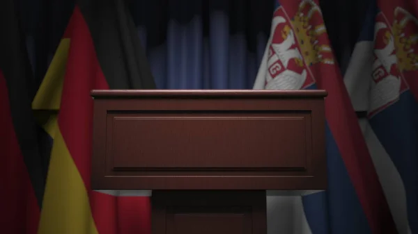 Banyak bendera Serbia dan Jerman di belakang tribun pembicara, rendering 3D — Stok Foto