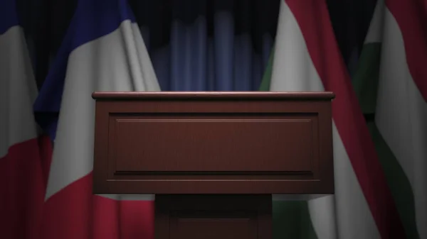 Σειρά σημαιών της Ουγγαρίας και της Γαλλίας και ομιλητής tribune, εννοιολογική 3d απόδοση — Φωτογραφία Αρχείου