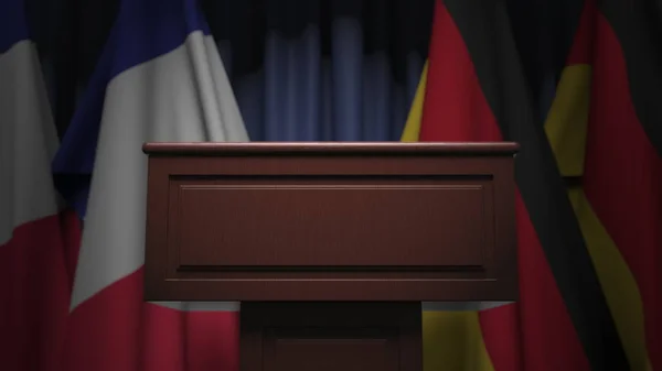 Πολλές σημαίες της Γερμανίας και της Γαλλίας πίσω από ομιλητής tribune, 3d απόδοση — Φωτογραφία Αρχείου