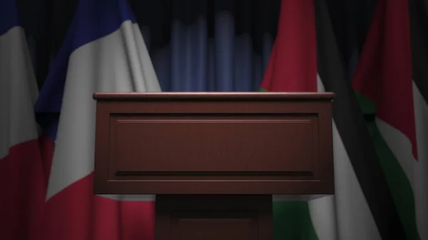 Πολλές σημαίες της Ιορδανίας και της Γαλλίας πίσω από ομιλητής tribune, 3d απόδοση — Φωτογραφία Αρχείου