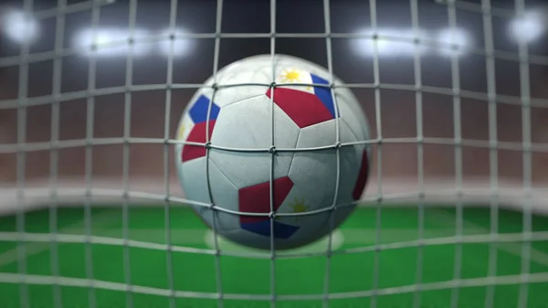 Football with flags of Philippines in net against blurred stadium. 3D rendering — Stock Photo, Image