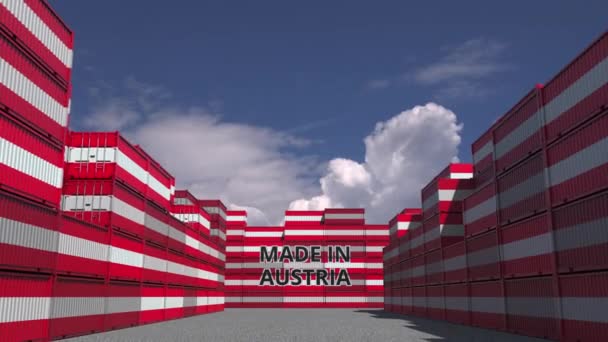 Many cargo containers with MADE IN AUSTRIA text and national flags. Austrian import or export related 3D animation — ストック動画