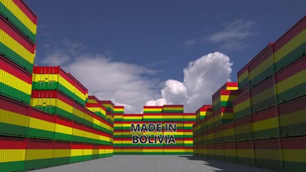 Many cargo containers with MADE IN BOLIVIA text and national flags. Bolivian import or export related 3D animation — Stock Video