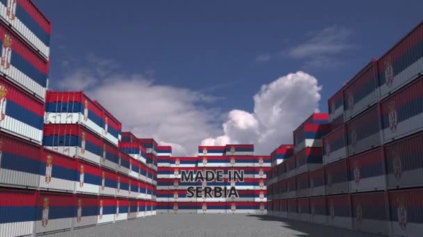 Cargo containers with MADE IN SERBIA text and national flags. Serbian import or export related 3D animation — Stockvideo