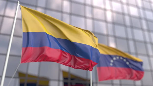 Waving flags of Colombia and Venezuela in front of a modern skyscraper facade. 3D rendering — Stock Photo, Image