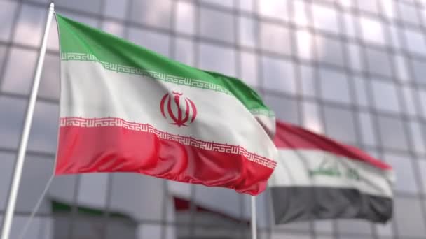 Waving flags of Iran and Iraq in front of a modern skyscraper facade — Stock Video