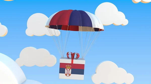 Коробка с национальным флагом Сербии падает с парашютом. 3D рендеринг — стоковое фото