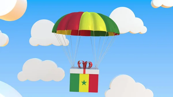 Caja con bandera nacional de Senegal cae con un paracaídas. Renderizado 3D — Foto de Stock